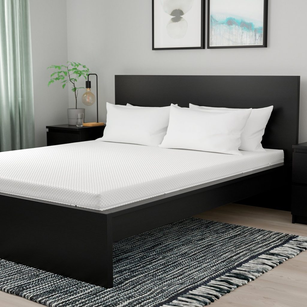 IKEA Åbygda su un letto in una camera arredata
